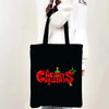 Black tote bag featuring a red Christmas design with stars and holly.