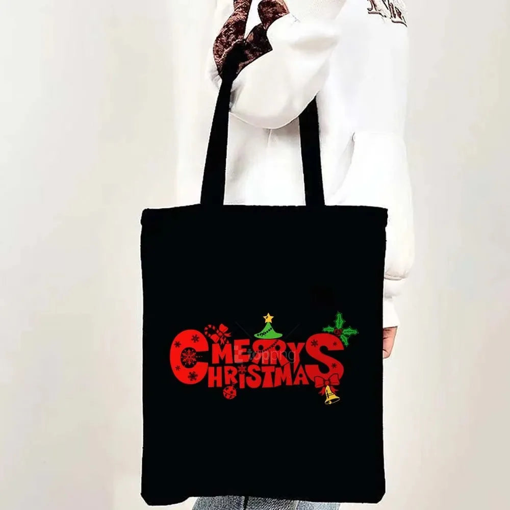Black tote bag featuring a red Christmas design with stars and holly.