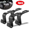 A set of four black car headrest hooks for bag storage, shown with a close-up view.