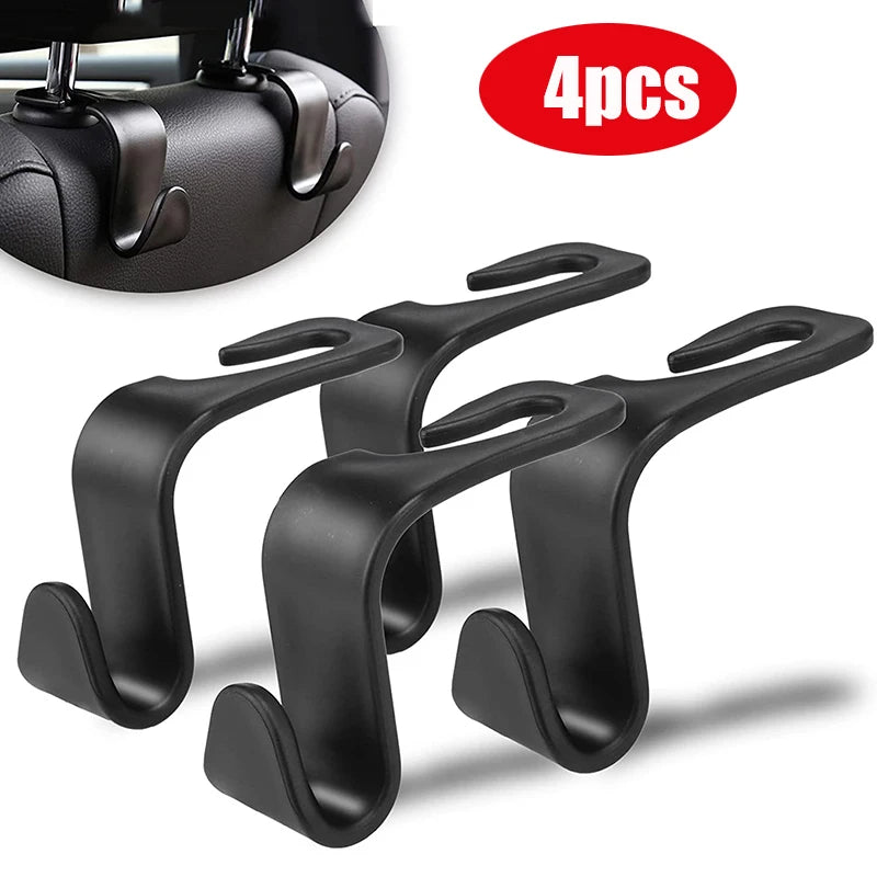 A set of four black car headrest hooks for bag storage, shown with a close-up view.