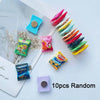 A collection of ten colorful candy-shaped refrigerator magnets in various shades and shapes.