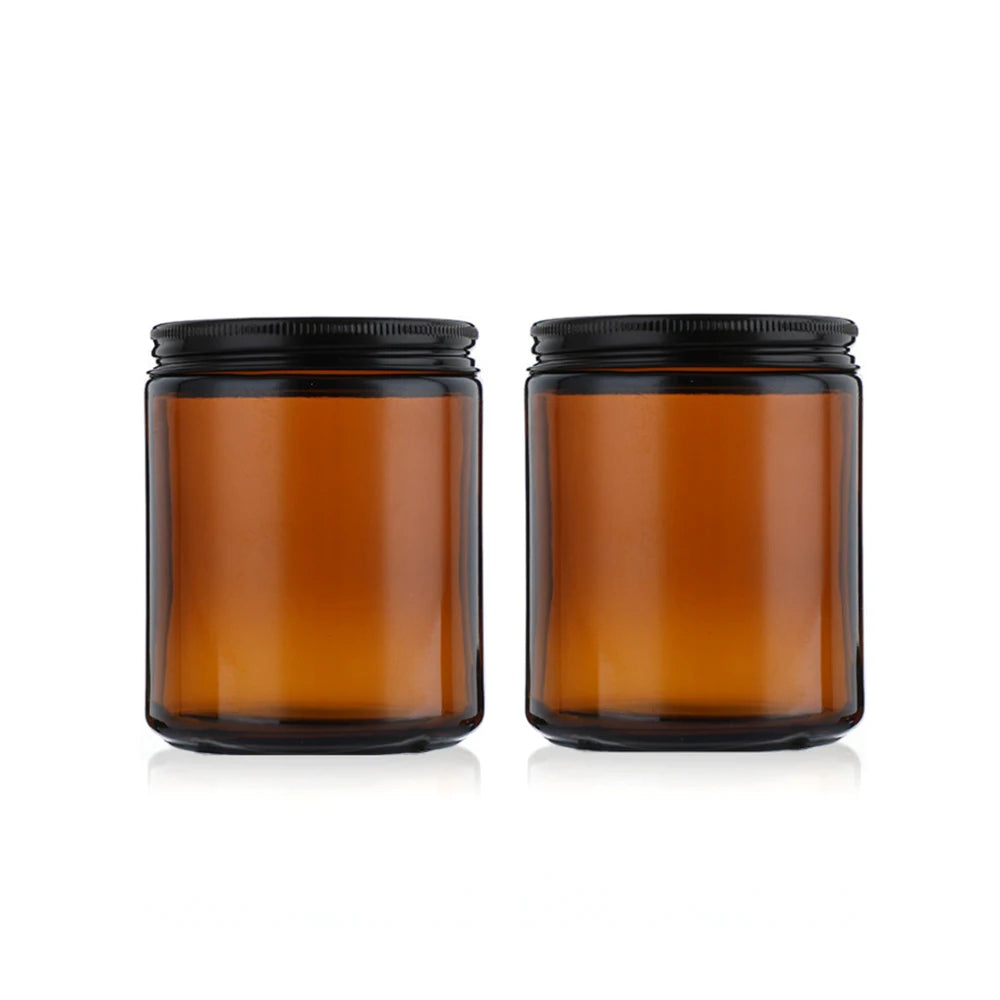 A set of two amber glass jars with black airtight lids and labels