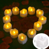 A collection of yellow flamed LED tealight candles arranged in a circle on a dark surface.