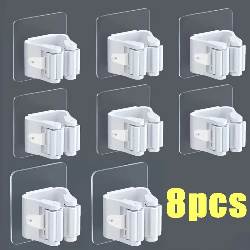 Eight white wall mounted holders for storing mops and brooms
