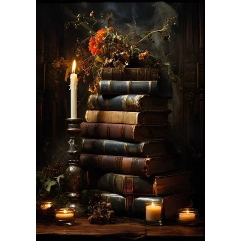A dark, moody still life featuring stacked old books, a lit candle, and dried foliage on a wooden surface.