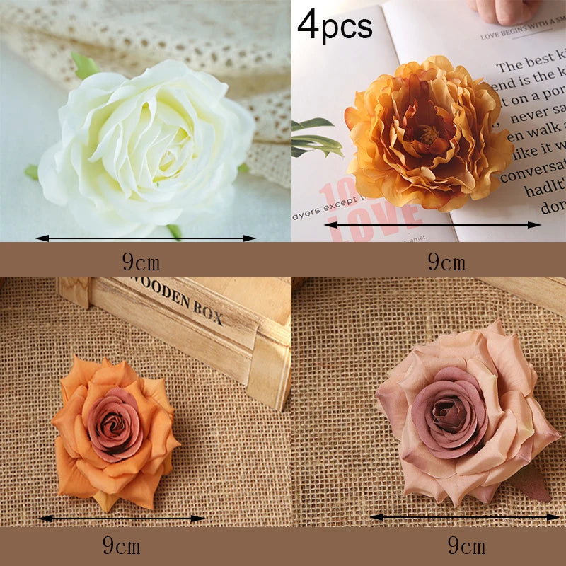 A set of four golden palm leaf cake toppers featuring detailed flower decorations in various shades of orange and pink.