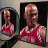 A framed canvas print of a basketball legend with a shaved head wearing a red jersey.