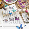 A collage of butterfly art stickers in various shades of blue and purple on a piece of paper.