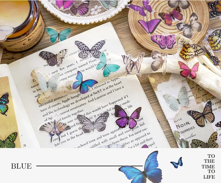 A collage of butterfly art stickers in various shades of blue and purple on a piece of paper.