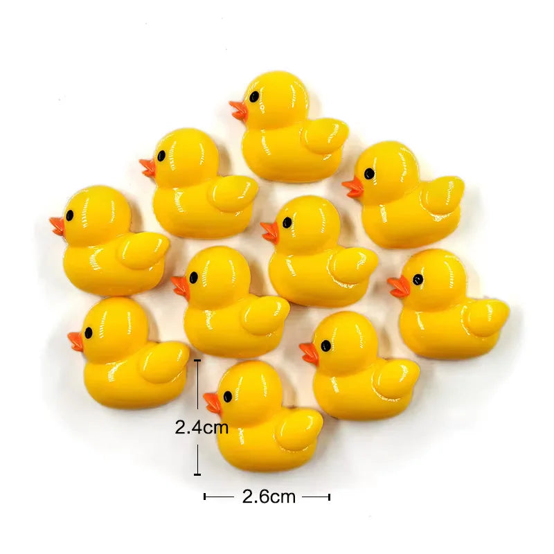 Un set de seis imanes de patitos amarillos brillantes agrupados.
