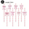 A set of ten pink striped straws with decorative pink bows for disposable party tableware.
