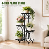 A black 4-tier metal plant stand displaying various green and pink plants in a bright room.