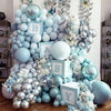 A large arrangement of dusty blue and silver latex balloons forming a letter B and Y for party decorations
