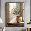 Canvas wall art featuring an olive tree in a terracotta pot set against a light wooden background.