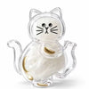 A clear capsule cat whisker keepsake magnet with white fur and gold accents.