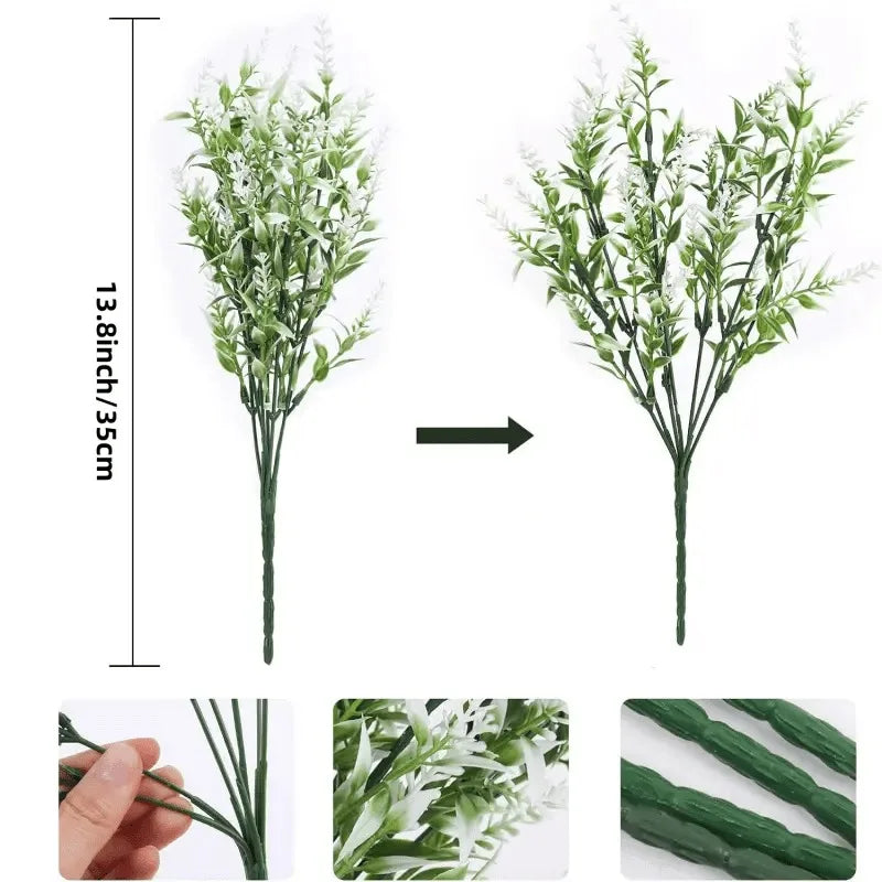 A vertical arrangement of artificial green foliage and white flowers displayed next to a scale.