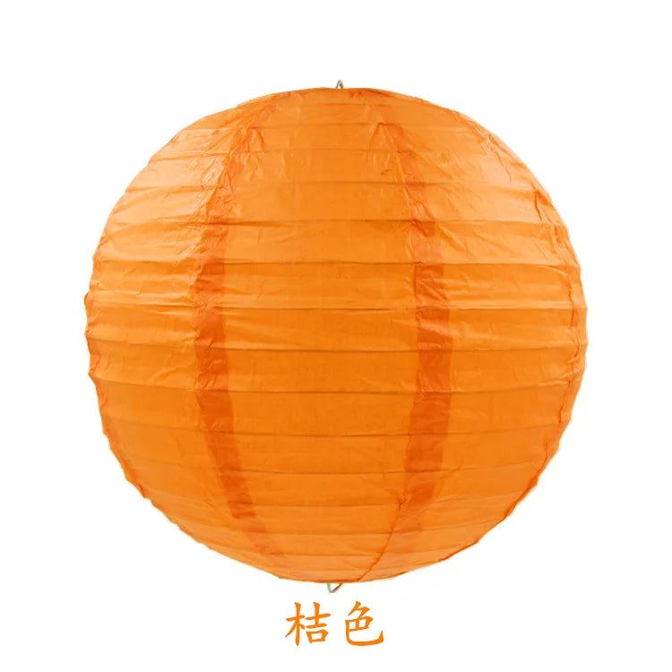 An orange round paper lantern used for parties and weddings.