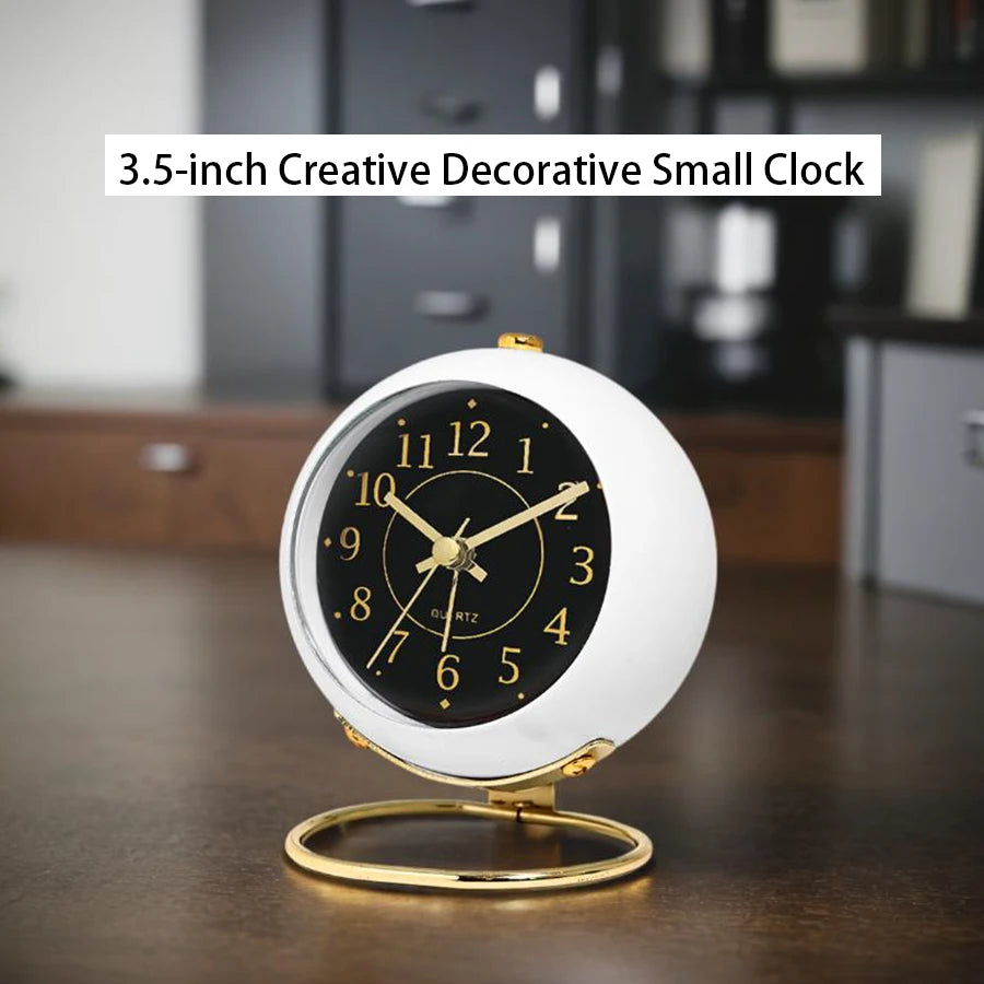 A 3.5-inch creative decorative small clock with a white face and gold accents sitting on a wooden surface.