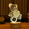 A white acrylic LED night light shaped like a teddy bear and a heart, illuminated on a wooden surface.