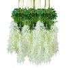 A hanging silk wisteria vine garland featuring green leaves and white flowers.