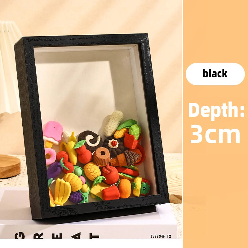 A black shadow box frame filled with colorful 3D objects and keepsakes.