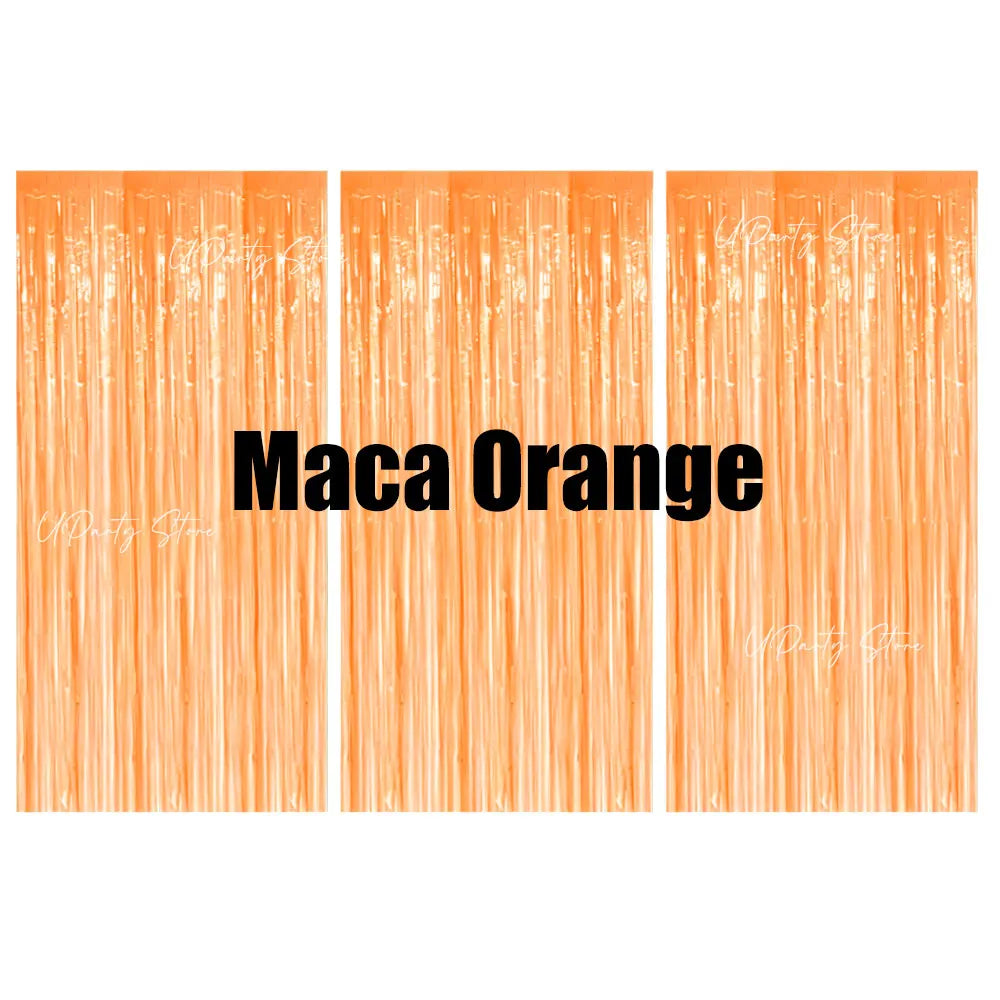 Vertical strips of orange metallic foil fringe curtains used as a party backdrop decor.