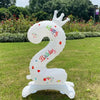 A white standing foil balloon shaped like a horse with the number 2 and the word happy birthday.