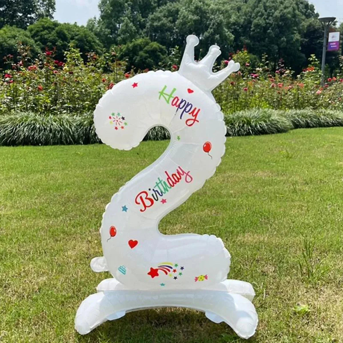 A white standing foil balloon shaped like a horse with the number 2 and the word happy birthday.