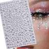 A sheet of glitter gems used for stick-on facial tattoos applied to an eye area.