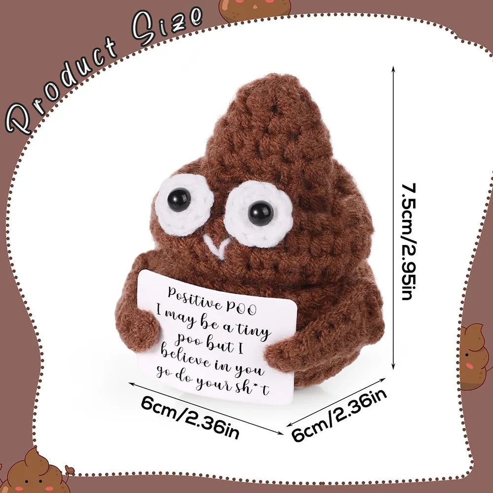 A handmade brown crochet potato doll with large eyes and an inspirational card attached.
