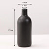 A matte black ceramic vase with a cylindrical body and a narrow neck, shown against a white background.