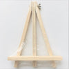 A wooden message board frame with a slanted support and a horizontal base, made of light wood.