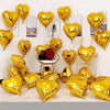 A collection of gold heart foil balloons arranged on a white background.