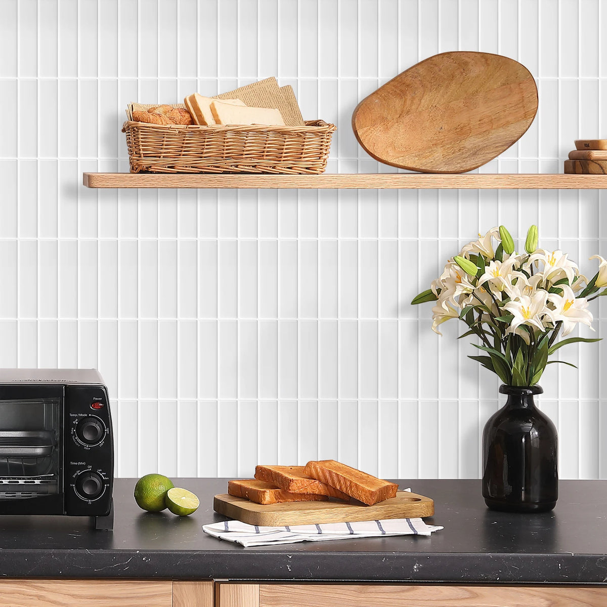 A wooden shelf displays bread and a large wooden cutting board against a white tiled wall.