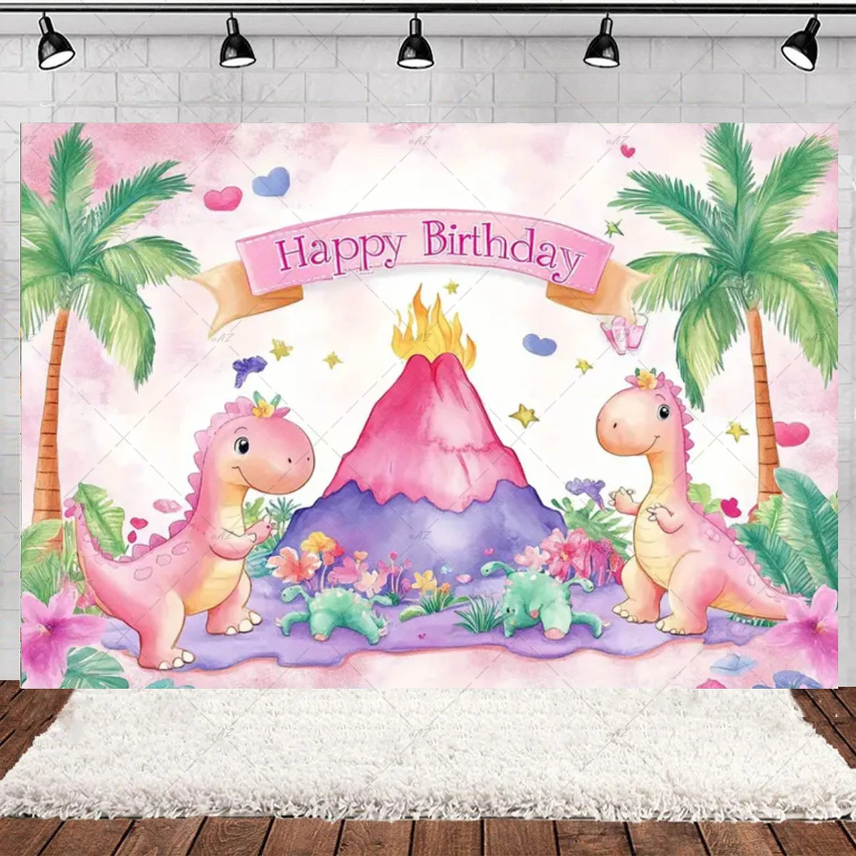 A watercolor illustration of pink dinosaurs celebrating a birthday with a fiery mountain backdrop and tropical leaves.