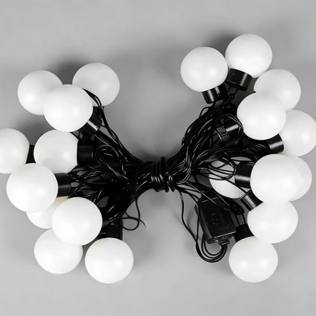 A cluster of large, spherical white marquee lights with black wiring for party decoration.