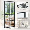 A tall, black-framed window mirror with multiple panes shown in a modern living room setting.