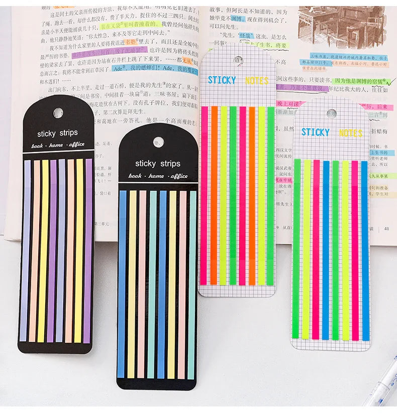 A collection of sticky strips and index tabs in various colors and designs for organization