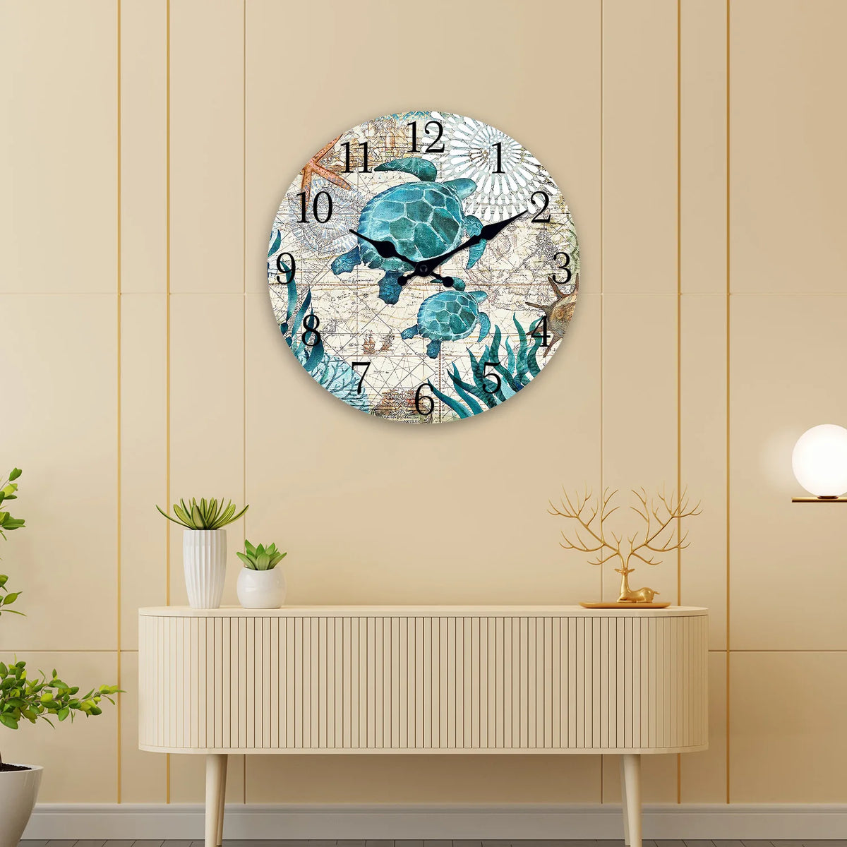 A round wall clock featuring a design of sea turtles in various shades of blue and green on a light background.