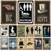A collection of vintage metal signs for bathroom decor featuring labels like WC, GENTS, LADIES, and TOILET.
