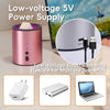 A pink low-voltage 5V power supply device used for electric heating, shown next to a laptop and various accessories.