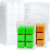 A stack of clear plastic clamshell molds containing small green and orange wax melts.