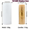 A tall, cylindrical mold for a chakra-sun pillar candle featuring celestial and mystical symbols.