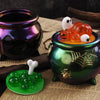 A set of Halloween silicone molds featuring pumpkins and ghosts displayed on a dark green ceramic jar.