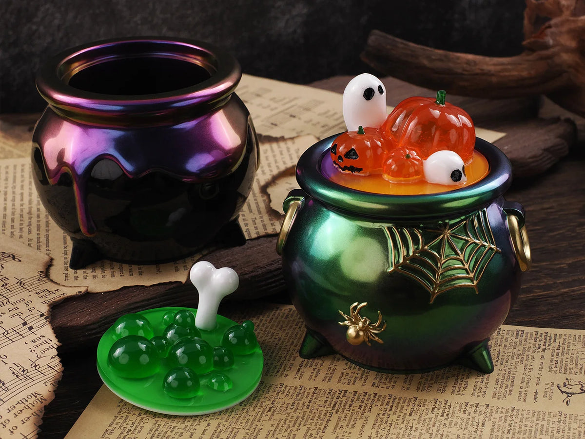A set of Halloween silicone molds featuring pumpkins and ghosts displayed on a dark green ceramic jar.