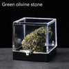 A rough green olivine stone specimen displayed inside a clear glass box.