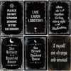 A collection of eight black metal tin signs featuring gothic and Halloween themed phrases like Live Lobotomy and She Herself 