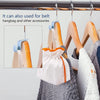 A set of wooden hanger connectors used for wardrobe organization, shown hanging on a rack.