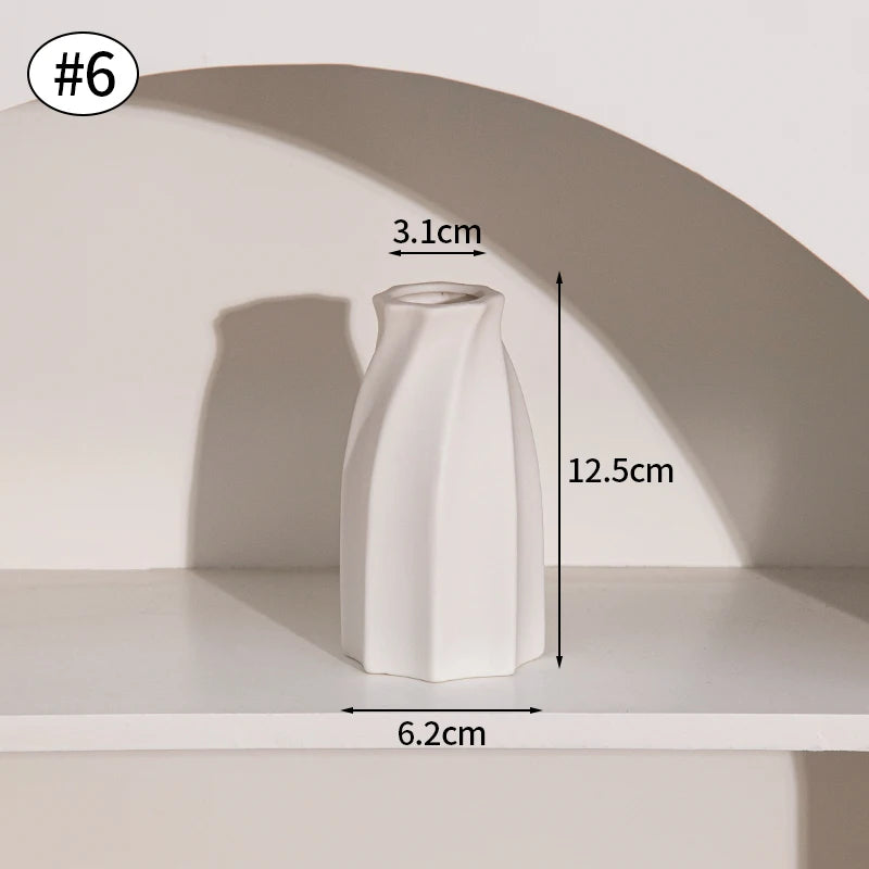 A white minimalist ceramic vase is displayed on a shelf, shown from the side with dimensions provided.