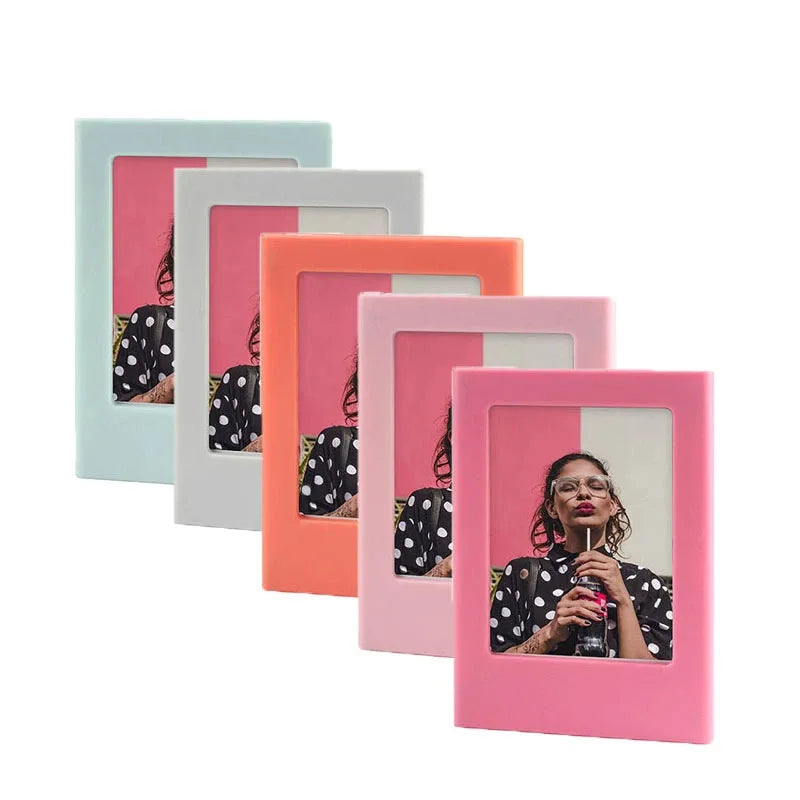 A row of five magnetic double-sided photo frames in pastel and coral colors.